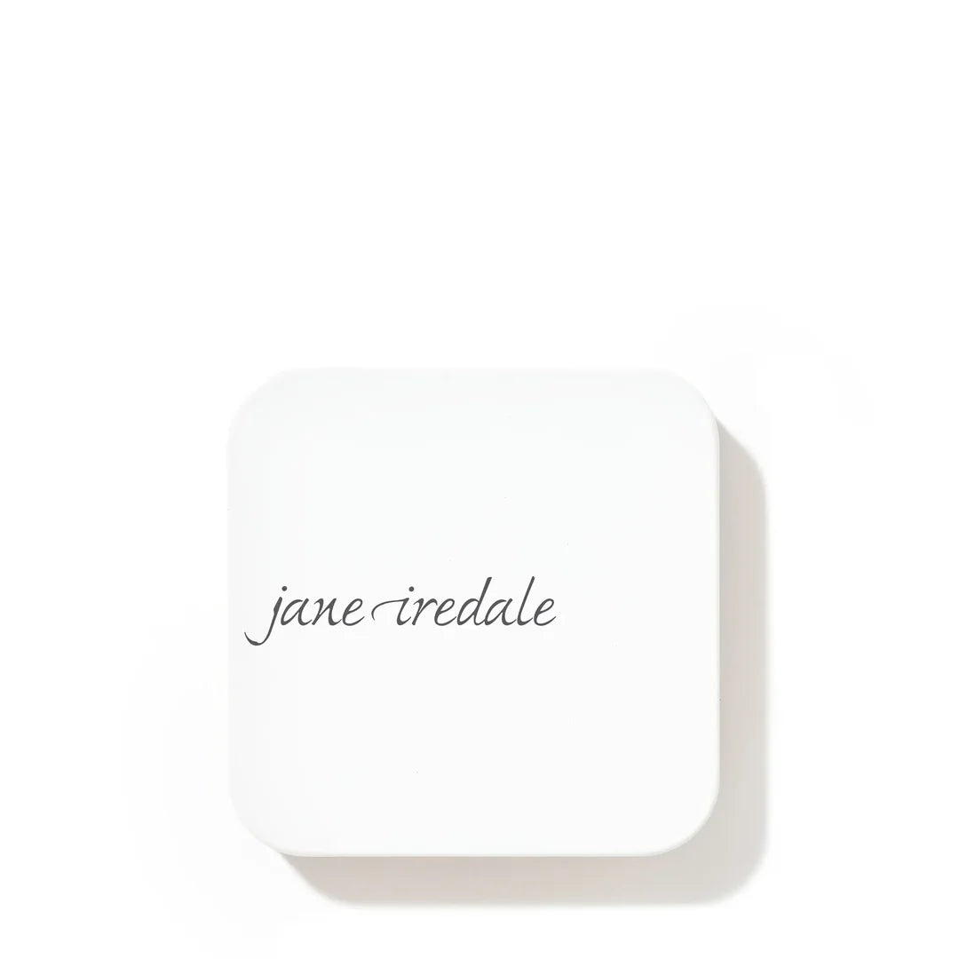 Closed white jane iredale refillable compact with the brand logo on the lid, shown on a white background.