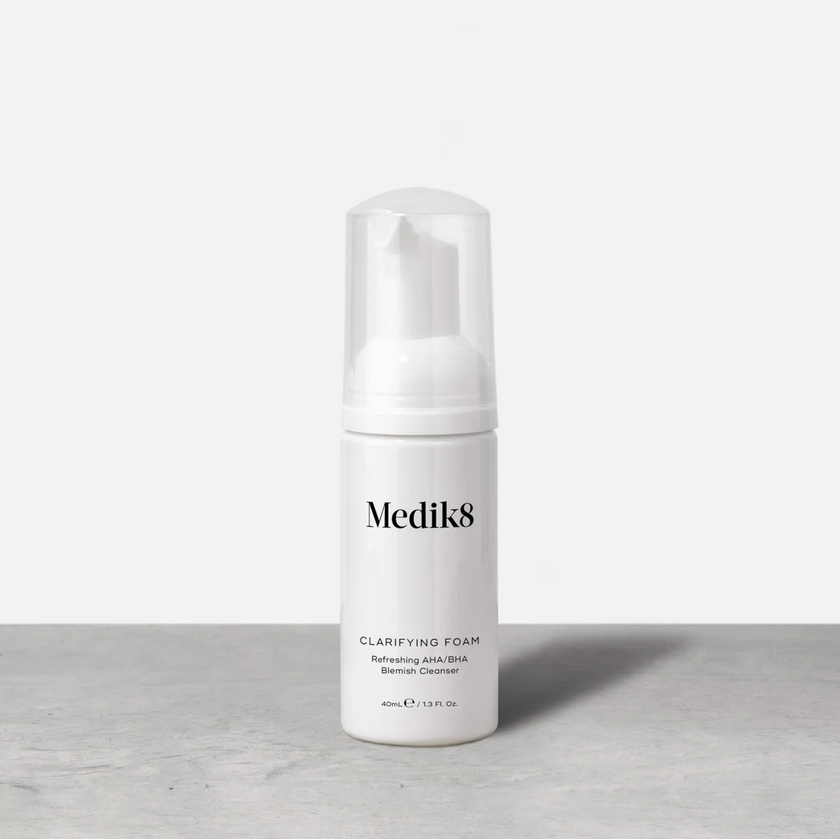 Medik8 Clarifying Foam 40ml white pump bottle on a grey table