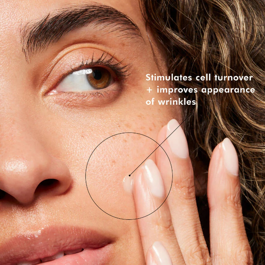 Model applying SkinCeuticals Retinol 1.0 cream to the cheek beside a caption about cell turnover and wrinkles.