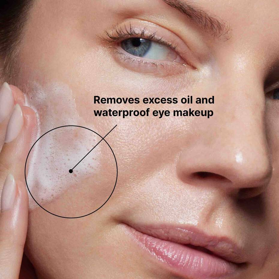 Model with SkinCeuticals Simply Clean gel cleanser applied to the cheek.