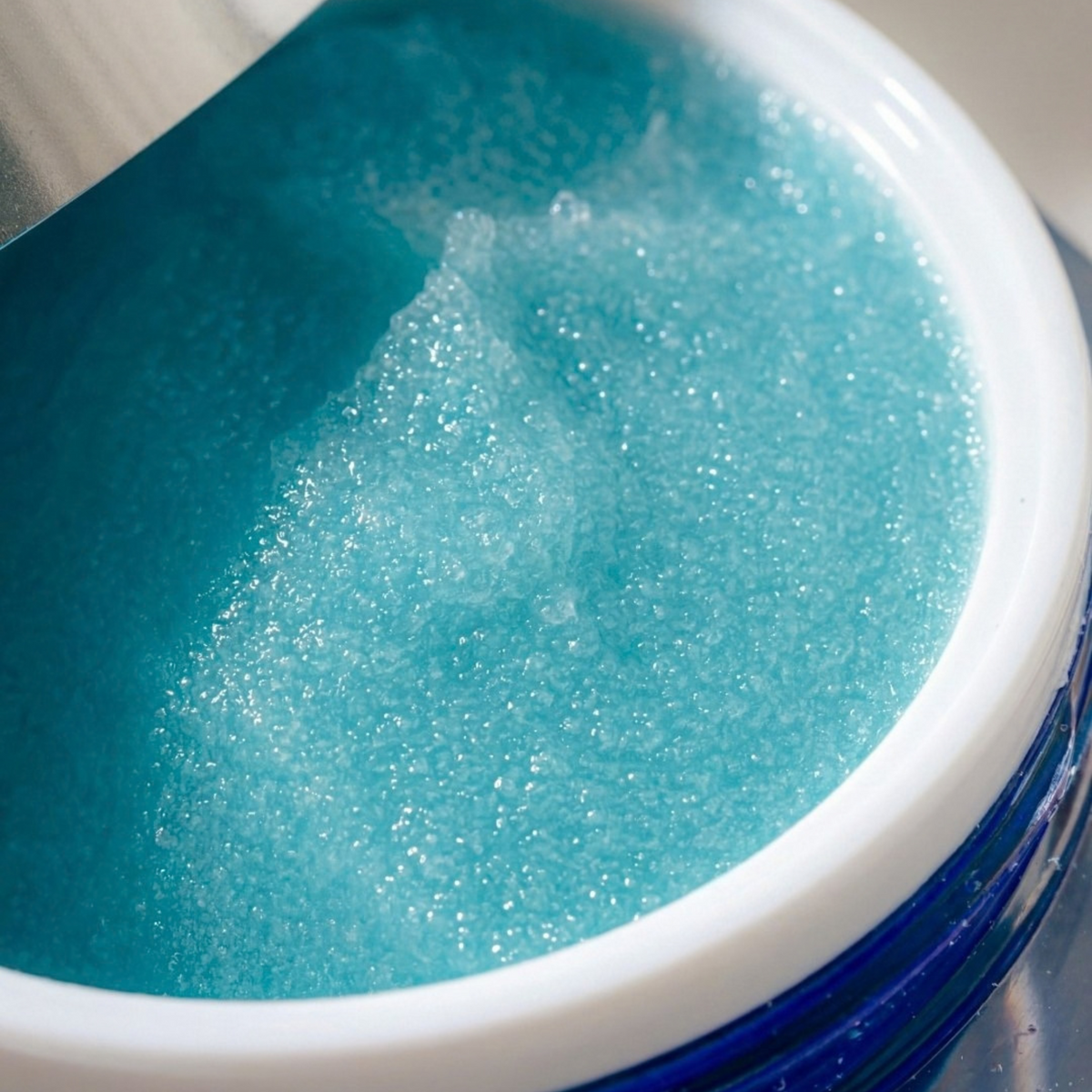 Close-up view of blue ZO Skin Health Exfoliating Polish inside its jar