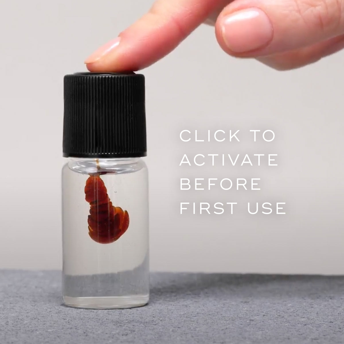 Finger pressing the black cap of a Medik8 Oxy-R Peptides bottle to activate the serum before first use.