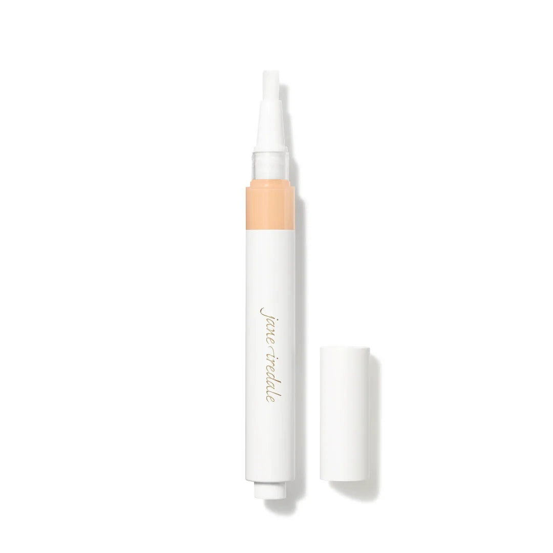 jane iredale Skintuition Concealer in L3, shown uncapped in a white applicator pen beside its lid on a white background.
