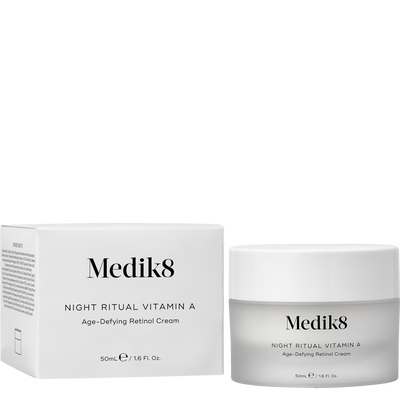 Medik8 Night Ritual Vitamin A Age-Defying Retinol Cream shown with its white outer box and a frosted glass jar with a white lid on a plain white background.