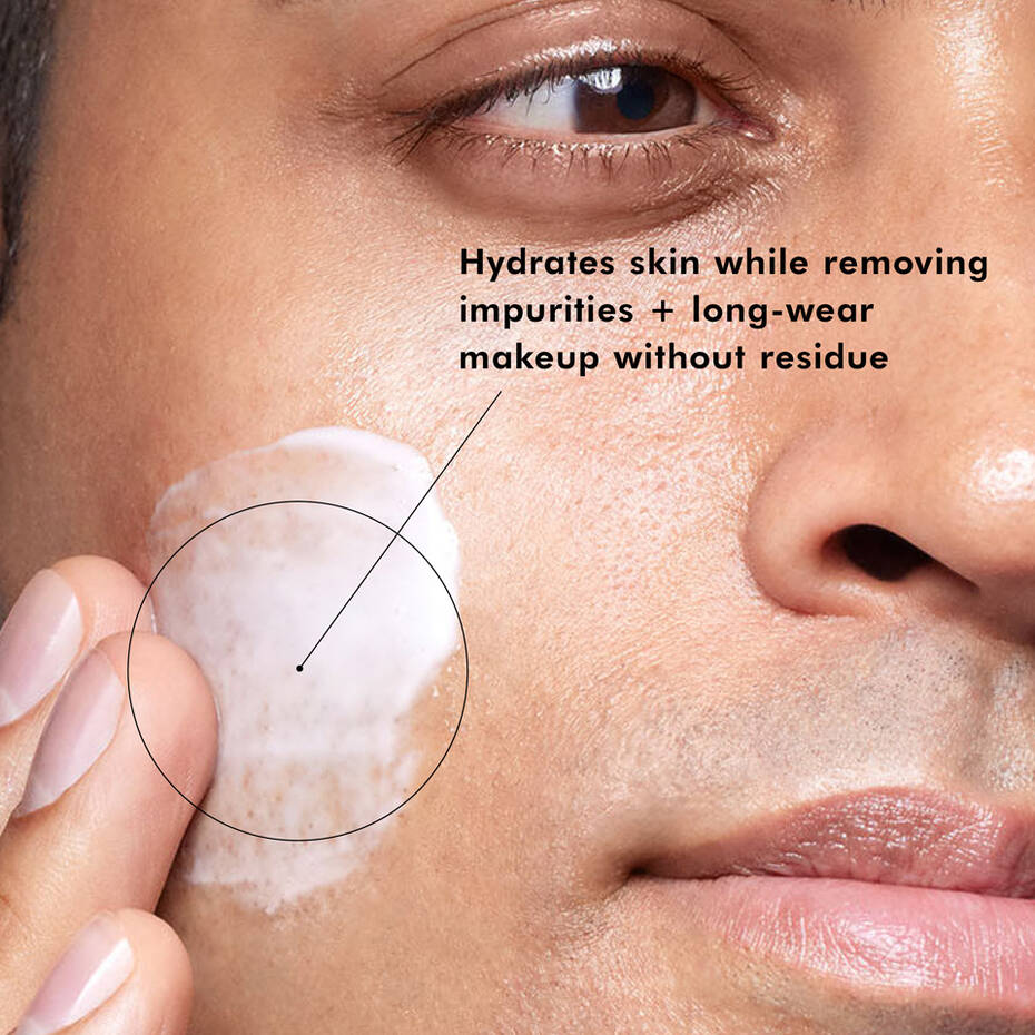Model applying SkinCeuticals Gentle Cleanser to the cheek.