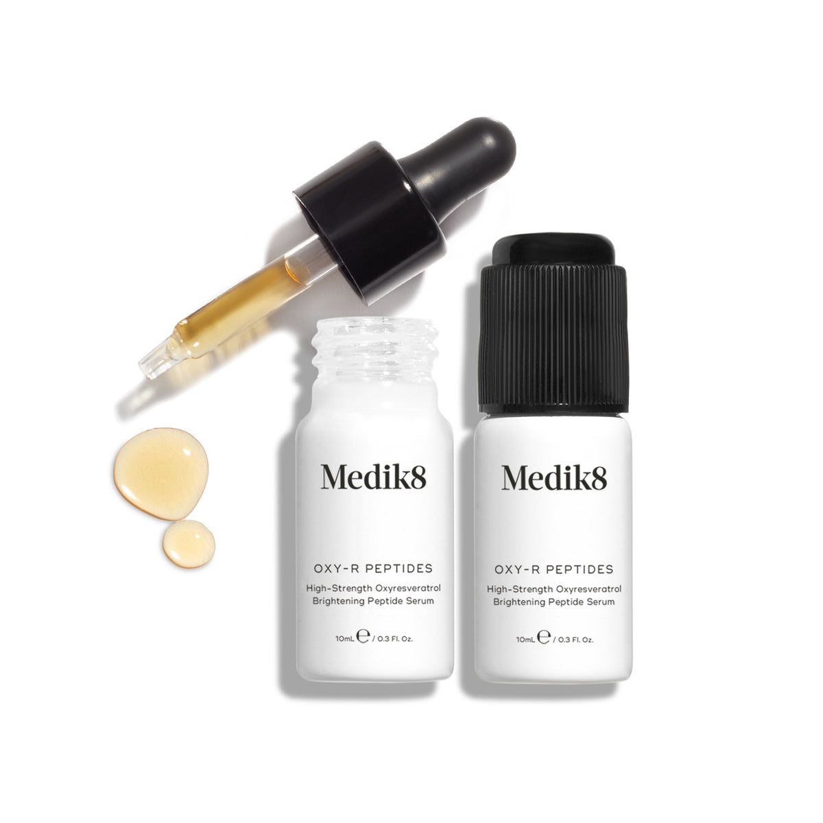 Medik8 Oxy-R Peptides serum bottles beside a glass dropper and golden serum droplets on a white background.